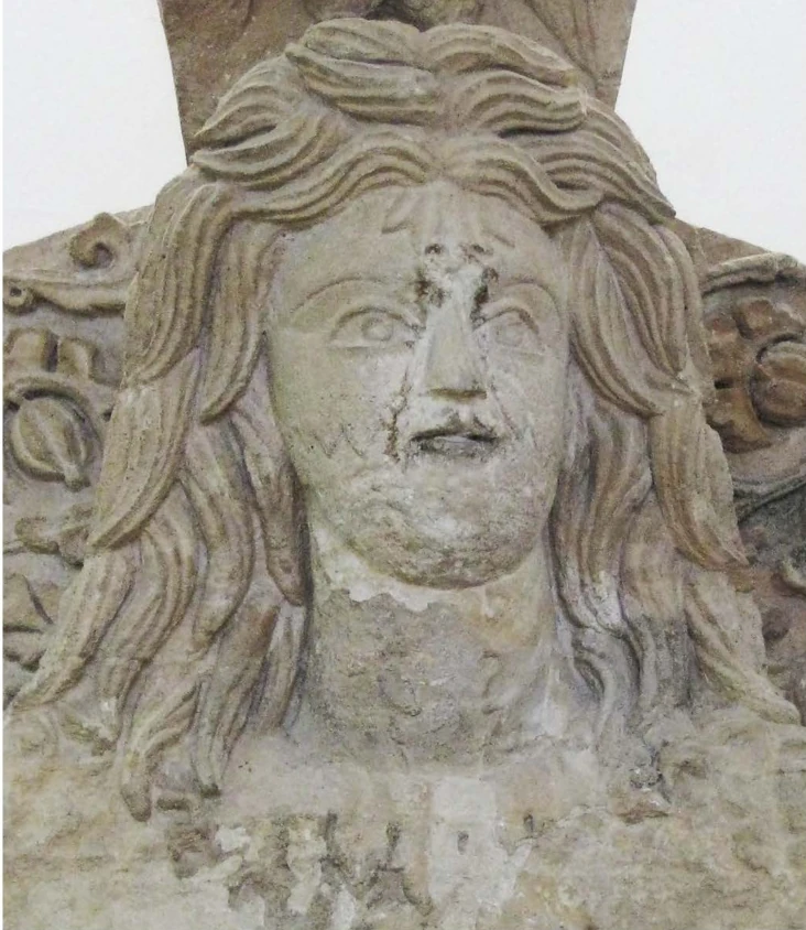 Photographed carved face fragment