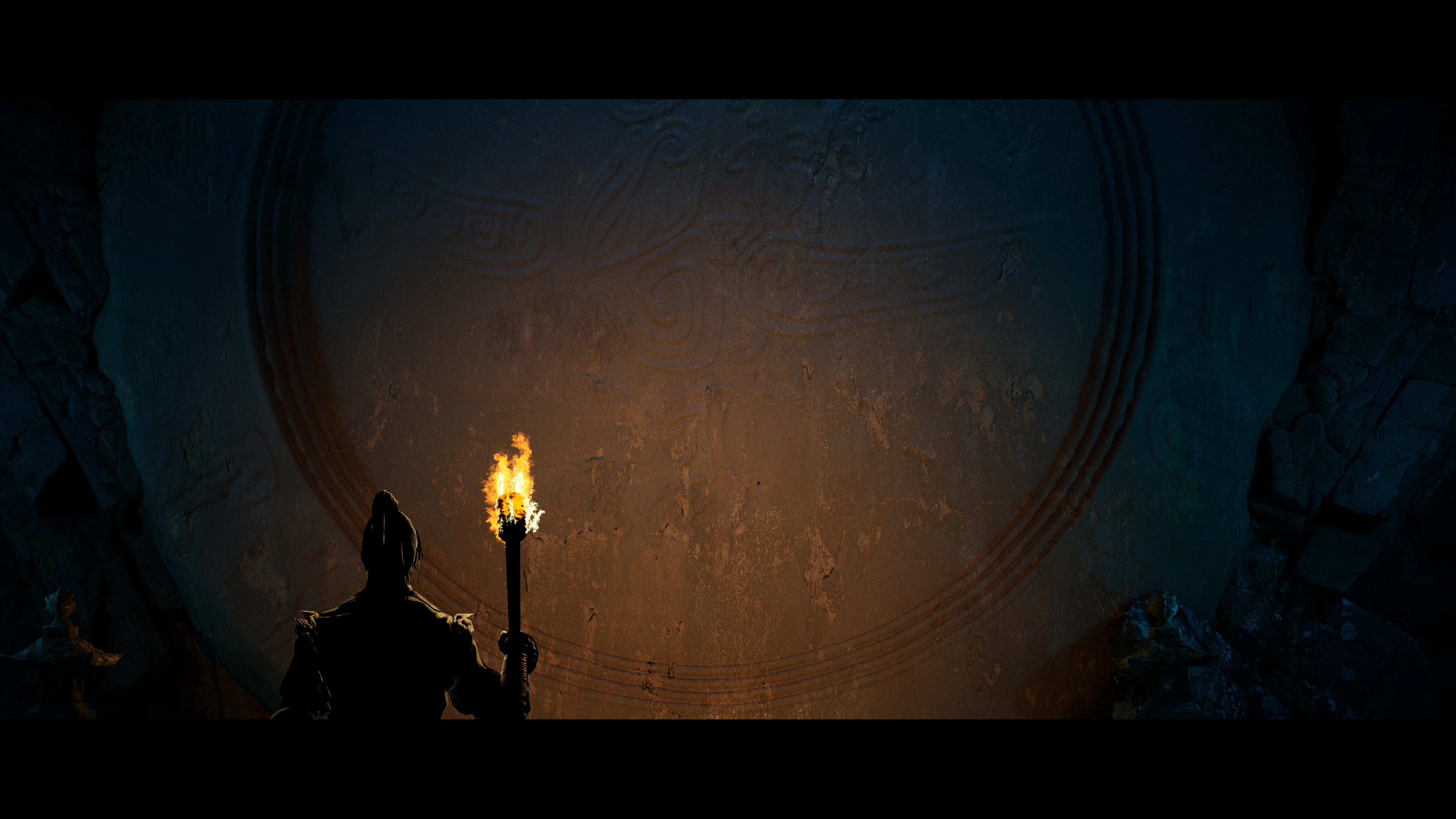 Torch-lit figure before the monumental gateway